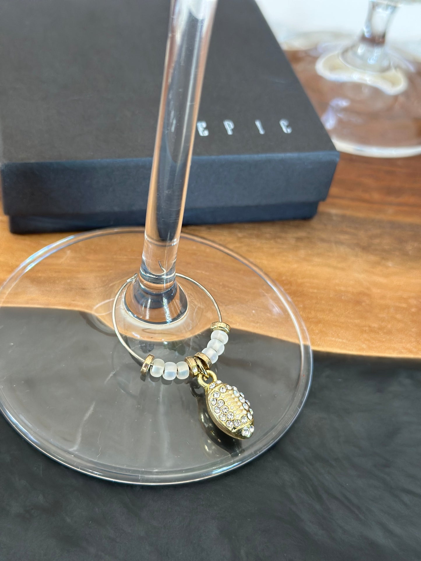 Gold football with rhinestones wine charm